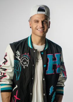 Profile of a man wearing glasses and a suit