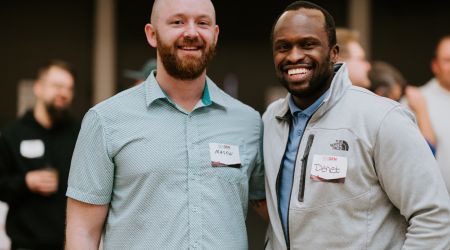Praying hands over open Bible